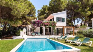 A modern villa with a swimming pool, outdoor seating, and lush greenery. - Casa Aina - Four Bedroom Villa, Sleeps 8 (Son Parc)