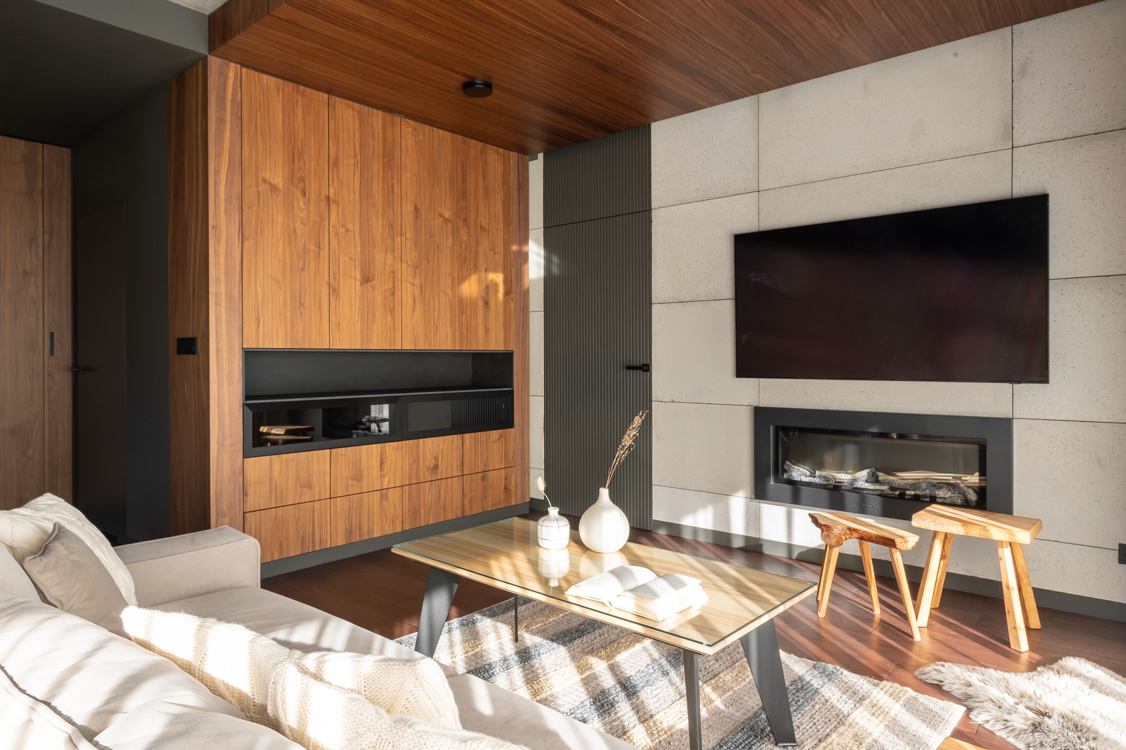 A modern living room with a sofa, coffee table, and a fireplace.