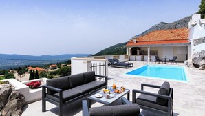 A rooftop pool area with a view of the countryside, a dining table with breakfast items, and outdoor seating. - Duka - One Bedroom Villa, Sleeps 2 (Dubravka, Konavle)