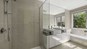 A modern bathroom with a glass shower enclosure, a double sink vanity, and a bathtub. - Anderson Central Townhouse - Walk to Shops & Beach (Torquay)