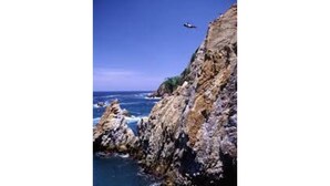 A coastal landscape with rocky cliffs and the ocean.