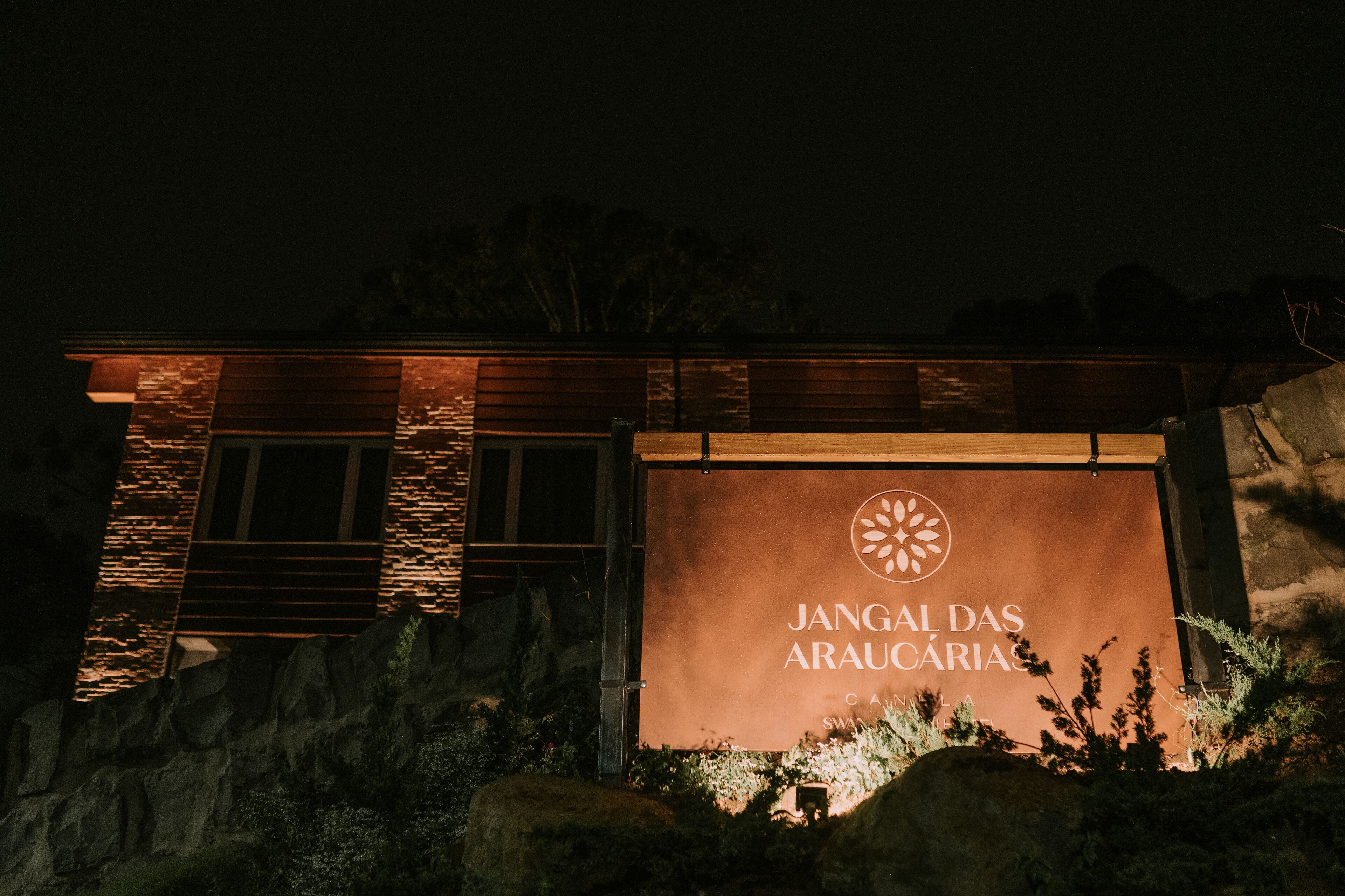 A building with a sign reading "Jangal das Araucárias" at night.
