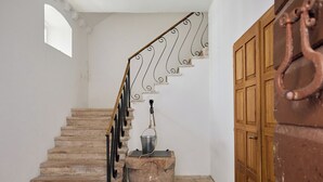 A staircase with a metal railing and a wooden door in the background. - Room Nino 2 - One Bedroom Apartment, Sleeps 2 (Dubrovnik)