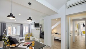 Una habitación moderna y bien iluminada con una mesa de comedor, sillas y una preparación para el desayuno.