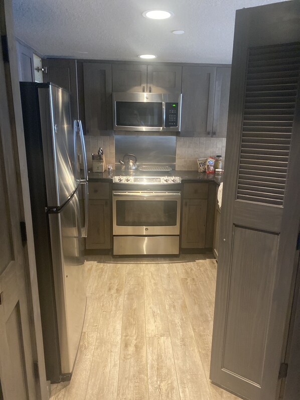 Enjoy cooking in this well-equipped kitchen with a refrigerator, microwave, and oven.