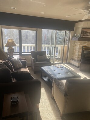 Relax in a comfortable seating area with a sofa, armchairs, and fireplace.