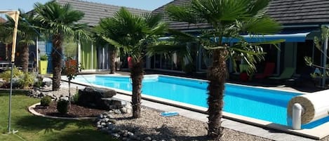 Seasonal outdoor pool, pool umbrellas, pool loungers