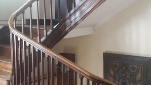 A wooden staircase with a handrail, wooden steps, and a wall-mounted clock. - Magnificent and large 18th century house, in a mountain village (Luz-Saint-Sauveur)