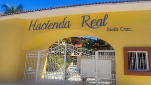 A yellow building with the sign 'Hacienda Real Santa Cruz'. - Nice condominium with lots of amenities. Huatulco (Crucecita)
