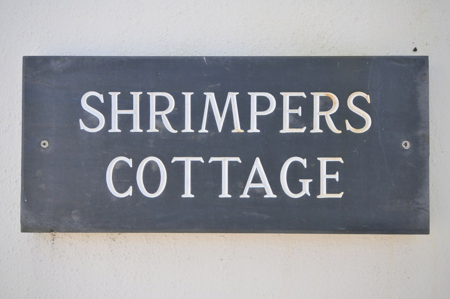 A sign with the words 'SHRIMPERS COTTAGE' on it.
