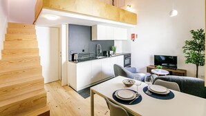 Um espaço compacto com cozinha compacta, área de refeições e assentos.