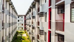 A modern apartment building with a central courtyard. - Relaxing 1-Bedroom Condo Unit (by Lee Portum) (Marilao)