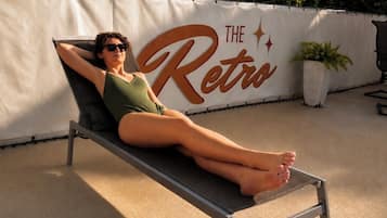 Seasonal outdoor pool, open 10:00 AM to 11:00 PM, pool umbrellas