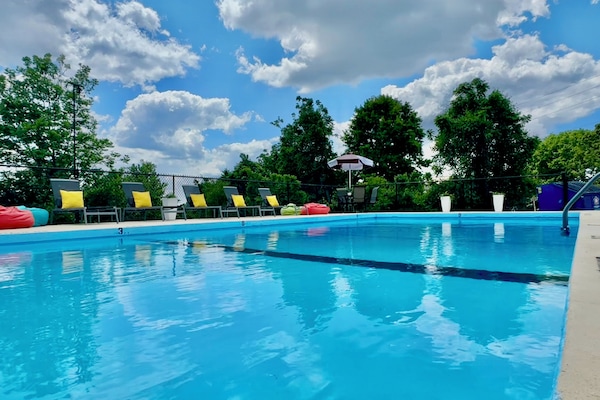 Seasonal outdoor pool, open 10:00 AM to midnight, pool umbrellas