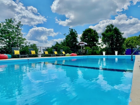 Seasonal outdoor pool, open 10:00 AM to midnight, pool umbrellas