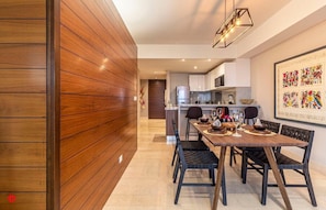Enjoy meals in this stylish dining area with a long table and comfortable chairs.