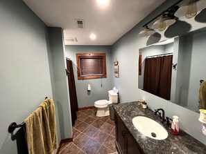Combined shower/bathtub, towels, soap, toilet paper