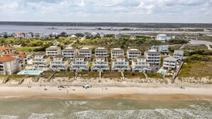 A beachfront hotel with multiple buildings, a sandy beach, and a view of the ocean. - Oceanfront Family Retreat / Pool, Hot Tub, Elevator, Well stocked kitchen (North Topsail)