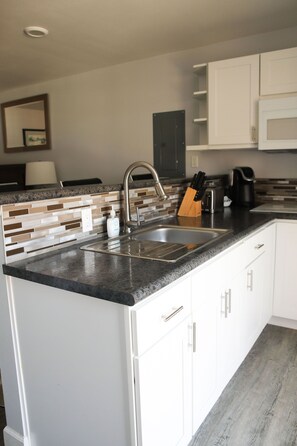 Fridge, microwave, stovetop, coffee/tea maker