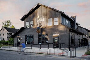A two-story building with a sign for 'Brown County Bikes' and 'Brown County Lodging & More'. - 3-East: Luxe 3BR in Downtown Nashville, IN w/ Rooftop Patio (Nashville)