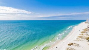 A beach with clear blue water and a sandy shore. - Updated Beachfront Condo w/private balcony and Pool (Gulf Shores)