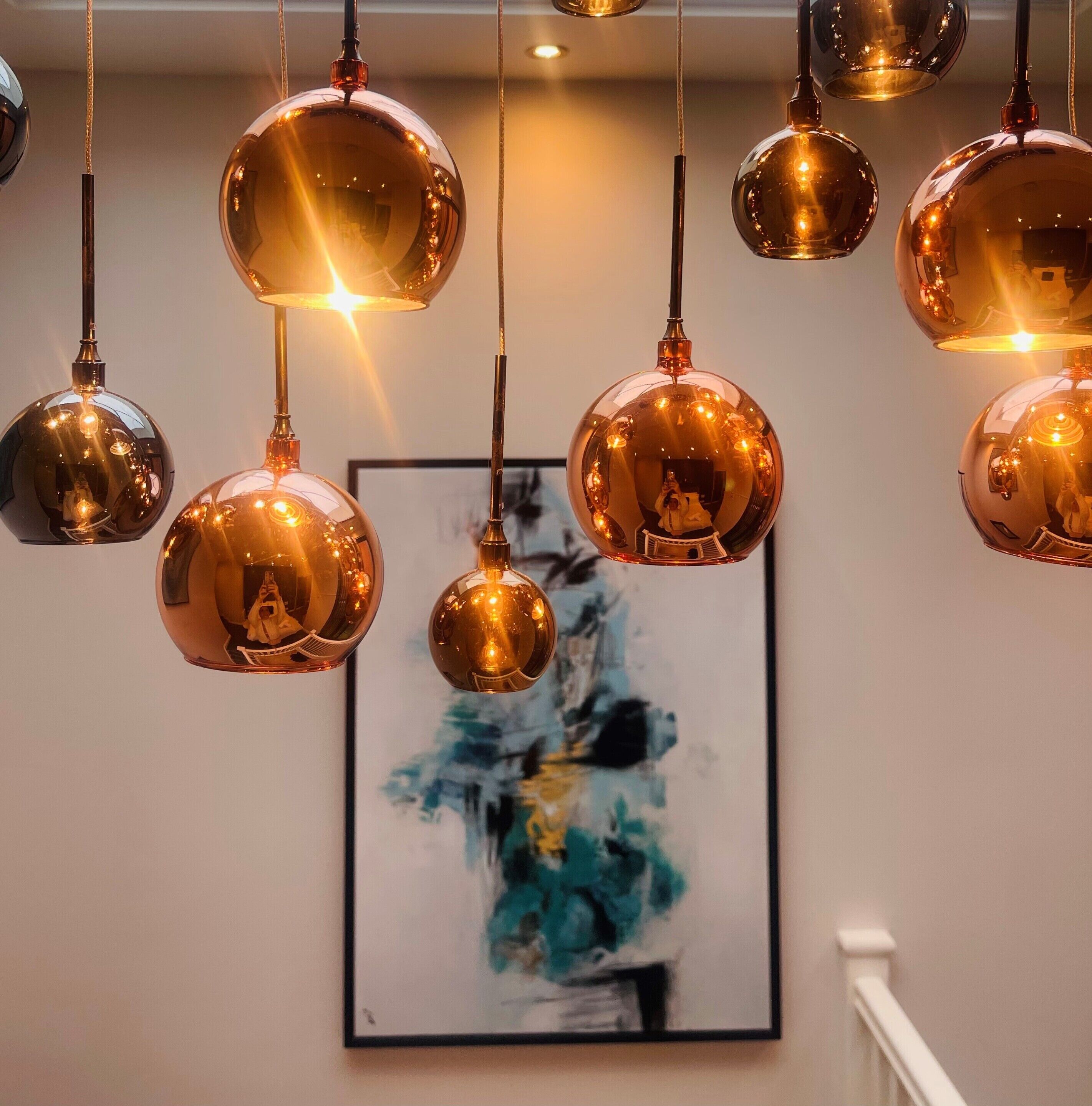 A series of spherical pendant lights with a warm glow, hanging from the ceiling.