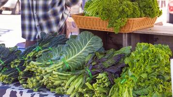 A variety of leafy greens displayed on a table at a market.