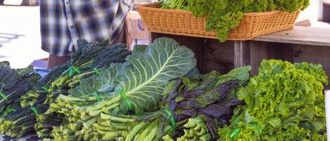 A variety of leafy greens displayed on a table at a market.