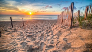 A beach with a wooden fence, sand, and the ocean. - Corolla Light Escape - Hot Tub + Beach Gear + Sunsets + Wifi (Corolla)