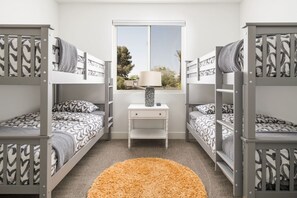 A room with bunk beds, a desk, and a window. - Luxury Oasis~3.5mi from Scottsdale~Pool~Game Rm (Scottsdale)