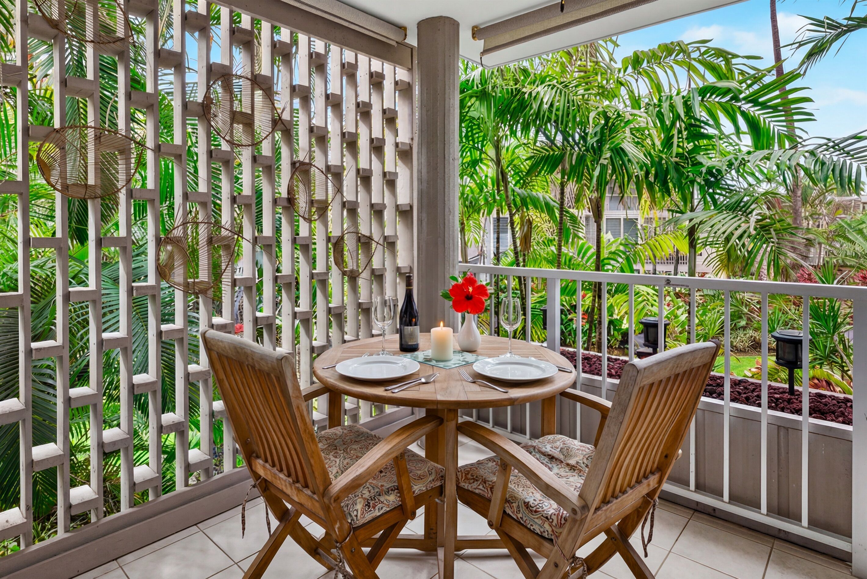 Private lanai dining area surrounded by lush tropical greenery—an inviting spot for morning coffee or a quiet meal outdoors.