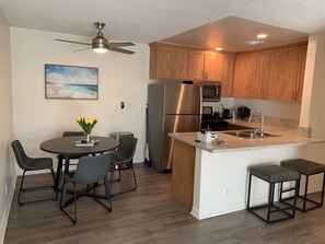 Enjoy cooking in this kitchen with a central island, sink, and ample counter space, flanked by appliances and cabinetry.