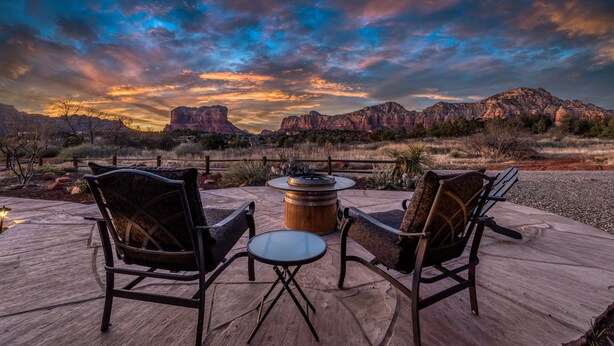 An outdoor seating area with two chairs and a table, overlooking a mountainous landscape. - Spacious Ranch House Sedona  (Sedona)