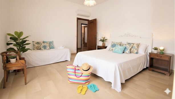 A bedroom with two beds, a wooden nightstand, a chair, a striped bag, and a hat. - Apartment with A/C 250m from beach | Ap19 (Diano Marina)