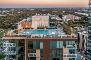 Enjoy the city view from our rooftop pool, surrounded by comfortable lounge chairs.