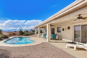 A pool area with a pool, lounge chairs, and a covered patio with a ceiling fan. - Private Pool, 3 Mi to Water! Lake Havasu City Home (Lake Havasu City)