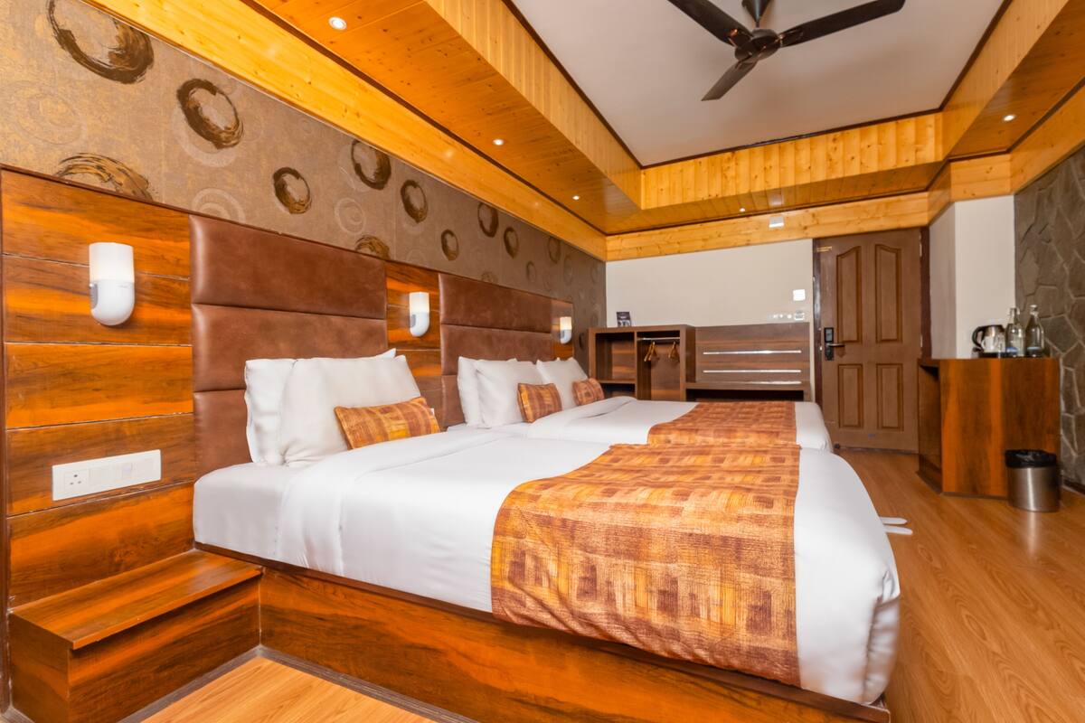 A large bed with a headboard, bedside tables, and a wooden ceiling.
