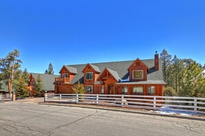 A large wooden lodge with multiple gabled roofs and a white fence in front. - Serenity Now Lodge by Destination Big Bear: Luxury Log Home in Castle Glen Estates! Hot Tub! Pool Table! Ping Pong! (Big Bear Lake)