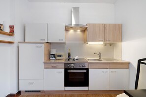 Fridge, stovetop, dishwasher, coffee/tea maker