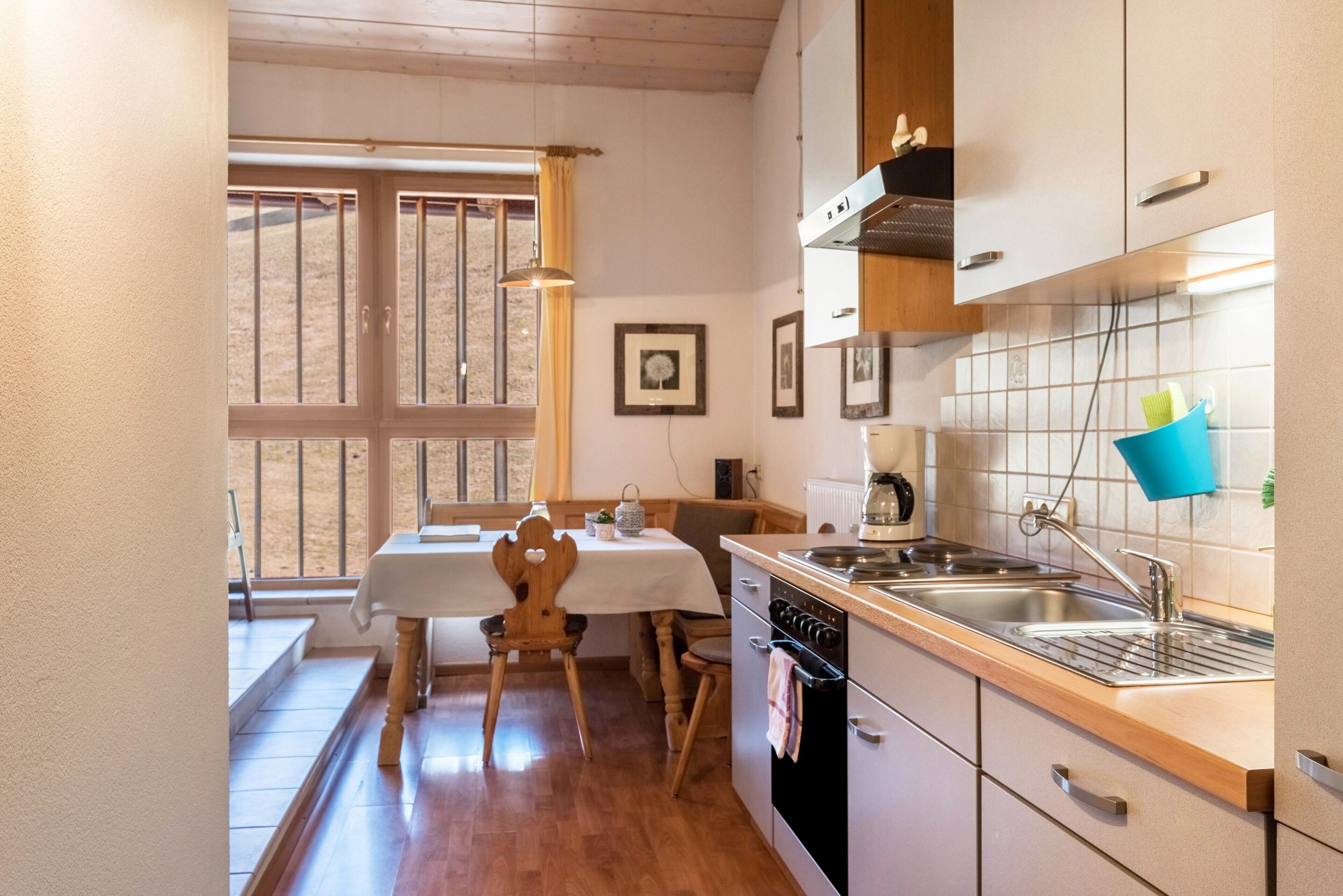 A kitchen with wooden cabinets, a stove, and a sink.