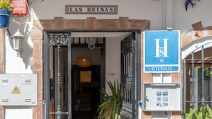 A hotel entrance with a sign reading "Las Brisas" and a blue sign with "H" and "CIUDAD". - Las Brisas Estepona (Estepona)
