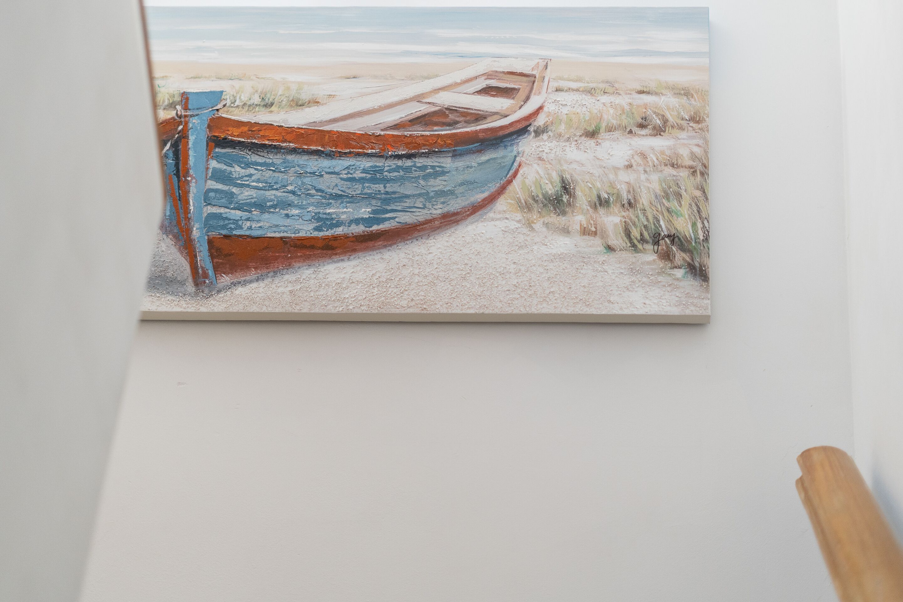 A painting of a boat on a sandy beach.