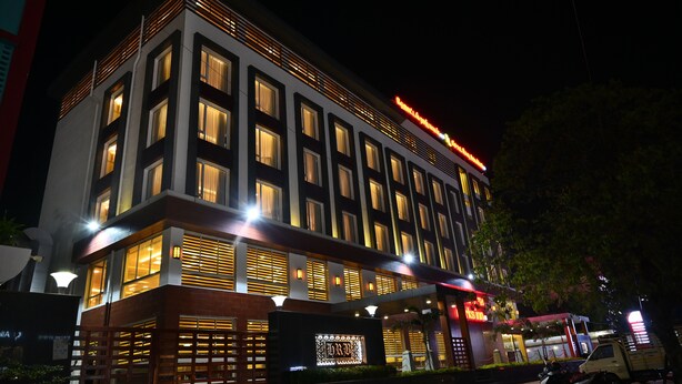 A multi-story hotel with illuminated windows and a prominent sign. - Raaj Bhaavan Clarks Inn Chennai (Chennai)