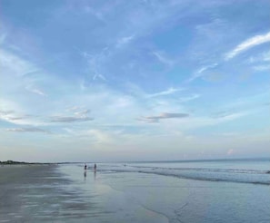 A beach with a clear sky and calm water.