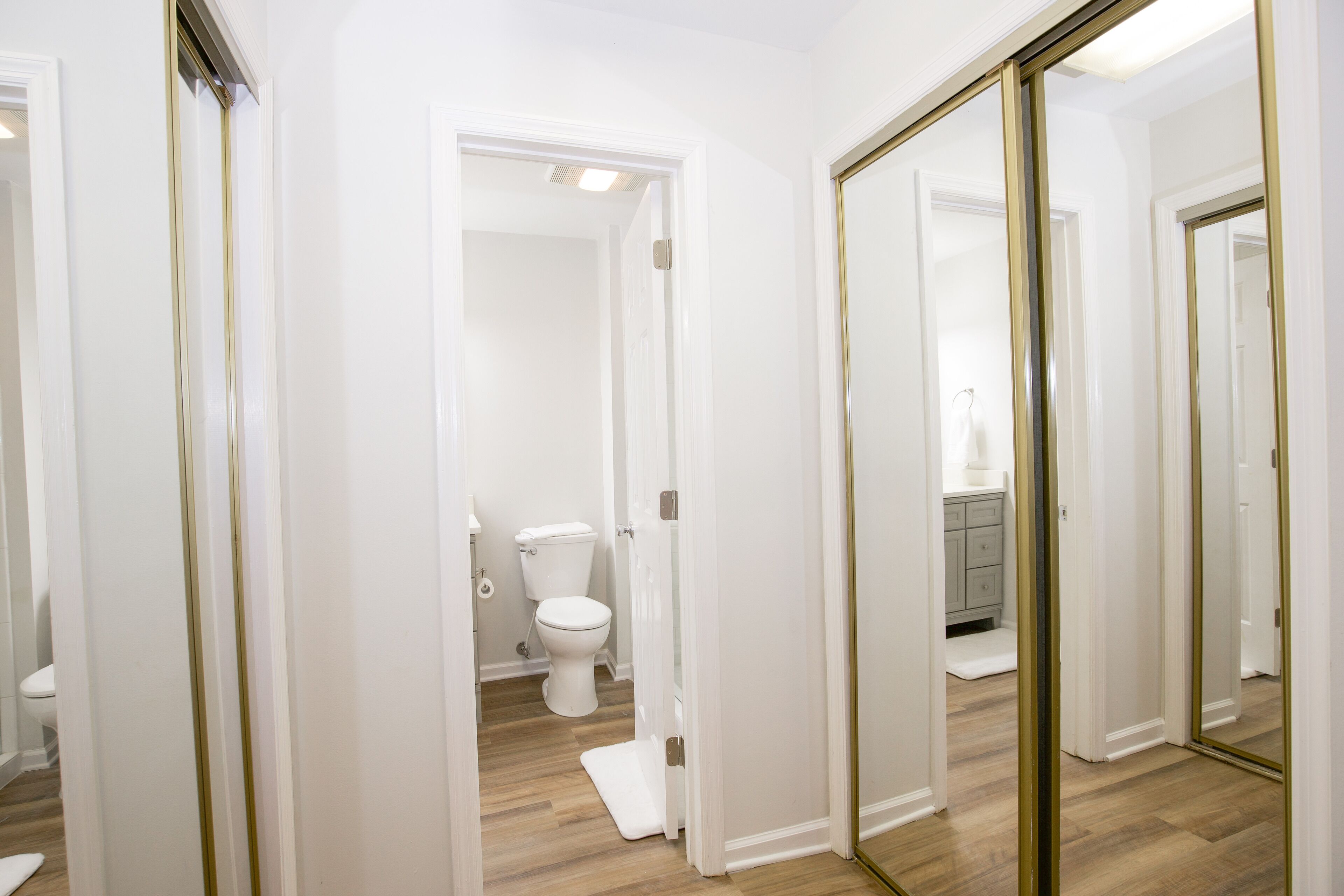 A bathroom with a toilet, a shower, and a sink.