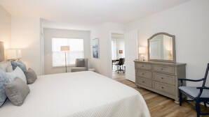 A bedroom with a large bed, a dresser, a chair, and a desk. - 19 F Pinehurst Manor: 1  BR, 1  BA Condominium in Pinehurst, Sleeps 3 (Pinehurst)