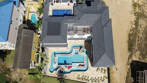 An aerial view of a resort with a large swimming pool, multiple buildings, and a beach area. - Last Minute Disney Getaway! Private Pool, Hot Tub & Game Room. Book Now! #6266 (Orlando)