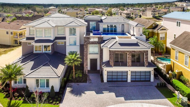 A modern two-story house with a garage, a swimming pool, and a well-maintained lawn. - Last Minute Disney Getaway! Private Pool, Hot Tub & Game Room. Book Now! #6266 (Orlando)