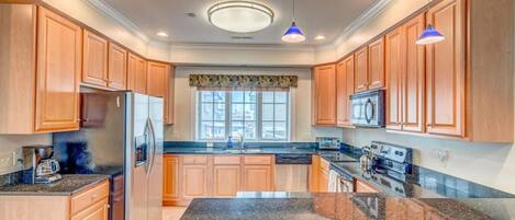 Fridge, coffee/tea maker, high chair, cookware/dishes/utensils