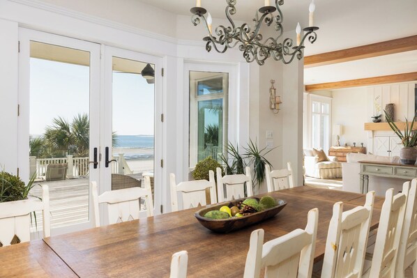 Enjoy meals with family and friends in this dining area, featuring a large window with a view of the ocean.